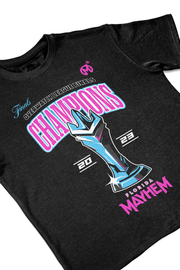A close up of black short-sleeved t-shirt featuring vibrant graphics. At the top, the word "Finals" in cyan is paired with "Overwatch League Finals" in pink. Below, the word "CHAMPIONS" is boldly displayed in pink, with a detailed blue and cyan trophy design beneath. The year 2023 flank the trophy, emphasizing the championship year. The phrase "Florida Mayhem" is written in bright pink at the bottom, with the team's small pink bomb logo placed near the collar.